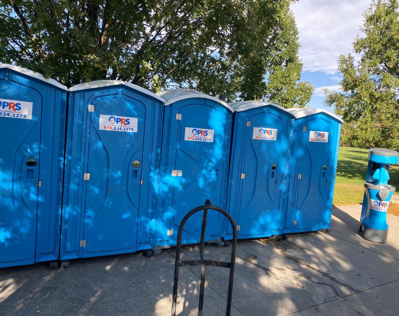 Crew unloading units for Porta potty rentals in Gunbarrel, CO at a community event setup