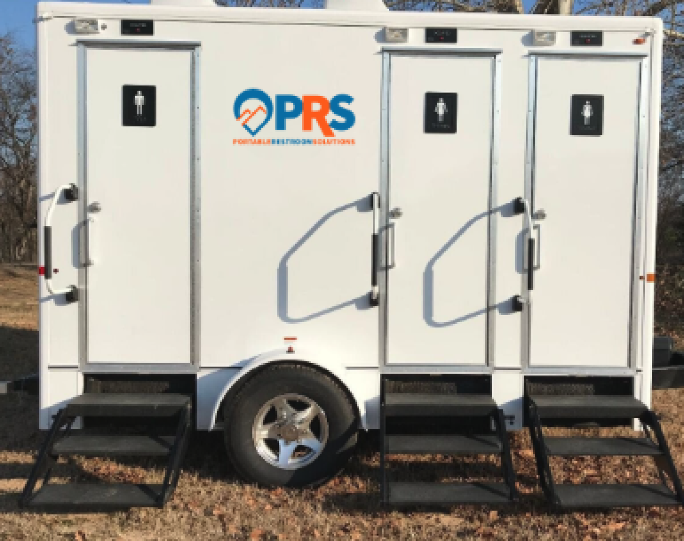 Luxury restroom trailer setup for Restroom trailer rental in Northglenn, CO at an outdoor wedding venue