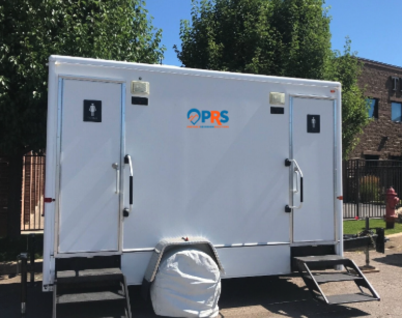Luxury trailer with lighting and decor during a Restroom trailer rental near me at an evening reception