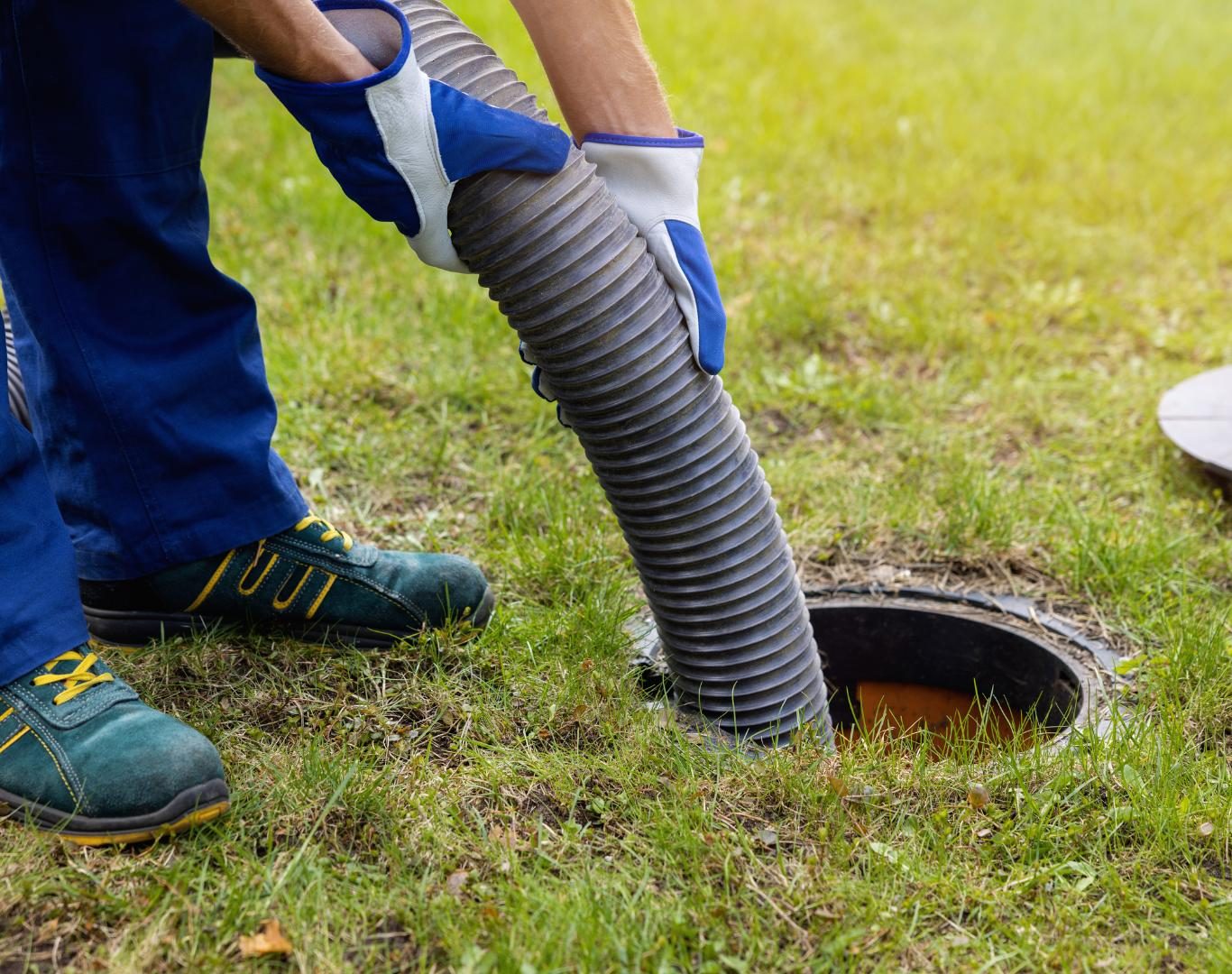 Technician operating vacuum truck for Septic pumping in Boulder, CO at a residential site