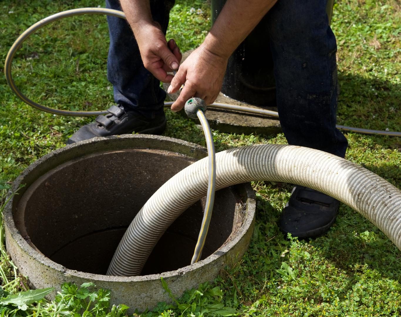 Technician preparing truck for Septic pumping in Longmont, CO at a residential property