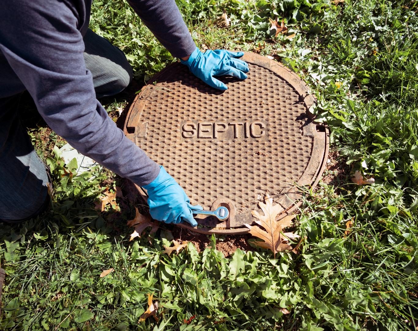 Technician using vacuum truck for Septic cleaning in Longmont, CO at a residential property